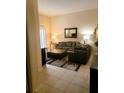 View of living room from entryway, showing sectional sofa and ottoman at 701 S Madison Ave # 106, Clearwater, FL 33756
