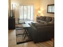 Living Room with sectional sofa, ottoman, and flat screen TV at 701 S Madison Ave # 106, Clearwater, FL 33756