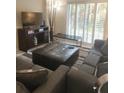 Living Room with sectional sofa, ottoman, and flat screen TV at 701 S Madison Ave # 106, Clearwater, FL 33756