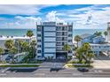 Oceanfront building exterior, showcasing parking and landscaping at 19106 Gulf Blvd # 102, Indian Shores, FL 33785