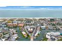 Aerial view of a coastal community with beach, water and various buildings at 175 116Th Ave # 102, Treasure Island, FL 33706