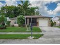 Single-story house with stone accents and a two-car garage at 4068 104Th N Ave, Clearwater, FL 33762