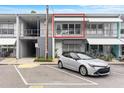 Front view of condo with parking and awning at 4071 55Th N Way # 1051, Kenneth City, FL 33709