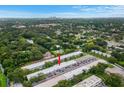 Aerial view showcasing the condo's location, landscaping, and distant city skyline at 4071 55Th N Way # 1051, Kenneth City, FL 33709