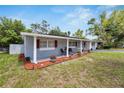 Single story home with grey siding and red shutters at 10837 109Th N St, Seminole, FL 33778