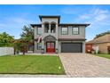 Beautiful two-story house with a red door, gray siding and a paved driveway at 6016 82Nd N Ter, Pinellas Park, FL 33781