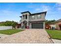 Beautiful two-story house with a red door, gray siding and a paved driveway at 6016 82Nd N Ter, Pinellas Park, FL 33781