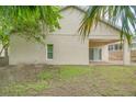 Back of house showing patio and fenced backyard at 1950 Lillian Ave, Tarpon Springs, FL 34689
