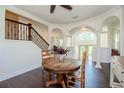 Small dining area with a wooden table and access to the upper level at 7340 Brightwaters Ct, New Port Richey, FL 34652