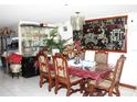 Dark wood table with six chairs, and a large decorative wall piece at 4521 16Th S Ave, Tampa, FL 33619