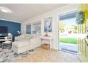 Living room with sectional sofa and blue accent wall at 10617 N 27Th St, Tampa, FL 33612