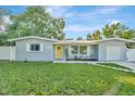 Cute ranch home with a yellow door and nicely landscaped yard at 10617 N 27Th St, Tampa, FL 33612