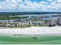 Stunning aerial view of the beach and ocean with a marker indicating the home's prime location at 704 180Th E Ave, Redington Shores, FL 33708