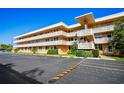 Spacious condo building with a parking area in front offering convenient access for residents and visitors at 5095 Bay Ne St # 114, St Petersburg, FL 33703