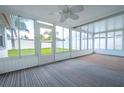 Bright sunroom with backyard view and carpet flooring at 3543 Seffner Dr, Holiday, FL 34691