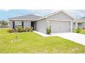 Newly built home with a two-car garage and well-manicured lawn at 102 Eagle Summit Dr, Ruskin, FL 33570