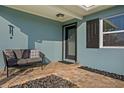 Inviting front porch featuring a comfortable bench, decorative rocks, and stylish accents on a beautifully painted home at 450 82Nd Ave, St Pete Beach, FL 33706