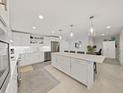 Modern kitchen with white cabinets, stainless steel appliances, and island at 920 N Osceola Ave # 201, Clearwater, FL 33755