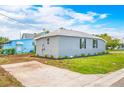 Newly renovated house exterior with gray siding, landscaping, and a paved driveway at 1757 9Th S Ave, St Petersburg, FL 33712