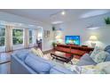 Bright living room featuring hardwood floors and a cozy sectional sofa at 1655 S Highland Ave # B216, Clearwater, FL 33756