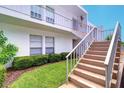 Well-maintained building exterior with stairs and landscaping at 1655 S Highland Ave # B216, Clearwater, FL 33756