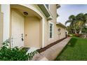 Tan house exterior with a walkway and landscaping at 462 Harbor Ridge Dr, Palm Harbor, FL 34683