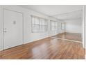 Living room with hardwood floors and large mirror at 5080 Locust Ne St # 329, St Petersburg, FL 33703