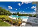 Inviting swimming pool with surrounding landscaping and patio at 13064 Via Flavia, Placida, FL 33946