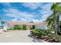 Ranch-style home with a large driveway and mature landscaping at 1884 Dolphin S Blvd, St Petersburg, FL 33707