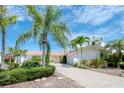 Single story home with pink door and tile roof, landscaped yard at 1884 Dolphin S Blvd, St Petersburg, FL 33707