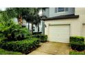 Townhouse exterior with attached garage and neat landscaping at 7643 Ginger Lily Ct, Tampa, FL 33619