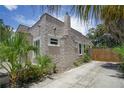 Side view of Spanish style home with stucco exterior and landscaping at 1817 20Th S Ave, St Petersburg, FL 33712