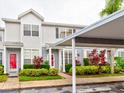 Townhouse with red door and carport at 2745 Enterprise E Rd # 24, Clearwater, FL 33759