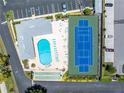 Aerial view showing community pool, tennis court, and parking at 4115 34Th S Way # 195, St Petersburg, FL 33711