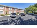 Brick condo building featuring assigned parking spaces and a well-maintained exterior at 4115 34Th S Way # 195, St Petersburg, FL 33711