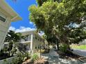 Building exterior showcasing a charming walkway and lush landscaping at 224 6Th N Ave # 12, St Petersburg, FL 33701