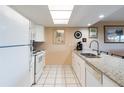 White kitchen with granite countertops and stainless steel appliances at 19610 Gulf Blvd # 308, Indian Shores, FL 33785