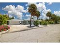 Cute bungalow with a large front yard, driveway, and garage at 850 Mandalay Ave, Clearwater Beach, FL 33767