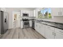 Modern kitchen with white cabinets and granite countertops at 850 Mandalay Ave, Clearwater Beach, FL 33767