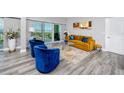 Living room with blue chairs, orange couch, and ocean view at 420 64Th Ave # A, St Pete Beach, FL 33706