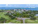 Wide aerial view showing a home near golf course and waterfront at 6 Hibiscus Ln, Belleair, FL 33756