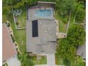 Aerial view of a home with a solar panel system and pool at 7323 Night Heron Dr, Land O Lakes, FL 34637