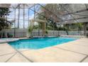 Inviting screened pool with pergola and spa at 7323 Night Heron Dr, Land O Lakes, FL 34637