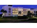 Condo building exterior at night, well lit at 50 Coe Rd # 311, Belleair, FL 33756