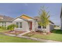 Cute one-story home with a red door and yellow trim at 13043 Pennybrook Dr, Riverview, FL 33579