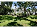 Condo building surrounded by green grass and trees at 702 Lyndhurst St # 824, Dunedin, FL 34698