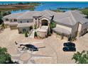 Luxury waterfront home with circular driveway and helicopter at 1227 Osowaw Blvd, Spring Hill, FL 34607