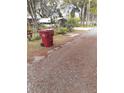 Trash can and surrounding landscaping in the front yard at 1401 W Spencer St, Plant City, FL 33563