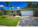 Well-maintained home with a lush front lawn and a spacious driveway at 10799 Harborside Dr, Largo, FL 33773