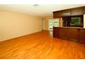 Open-concept living room and kitchen with hardwood floors at 10799 Harborside Dr, Largo, FL 33773